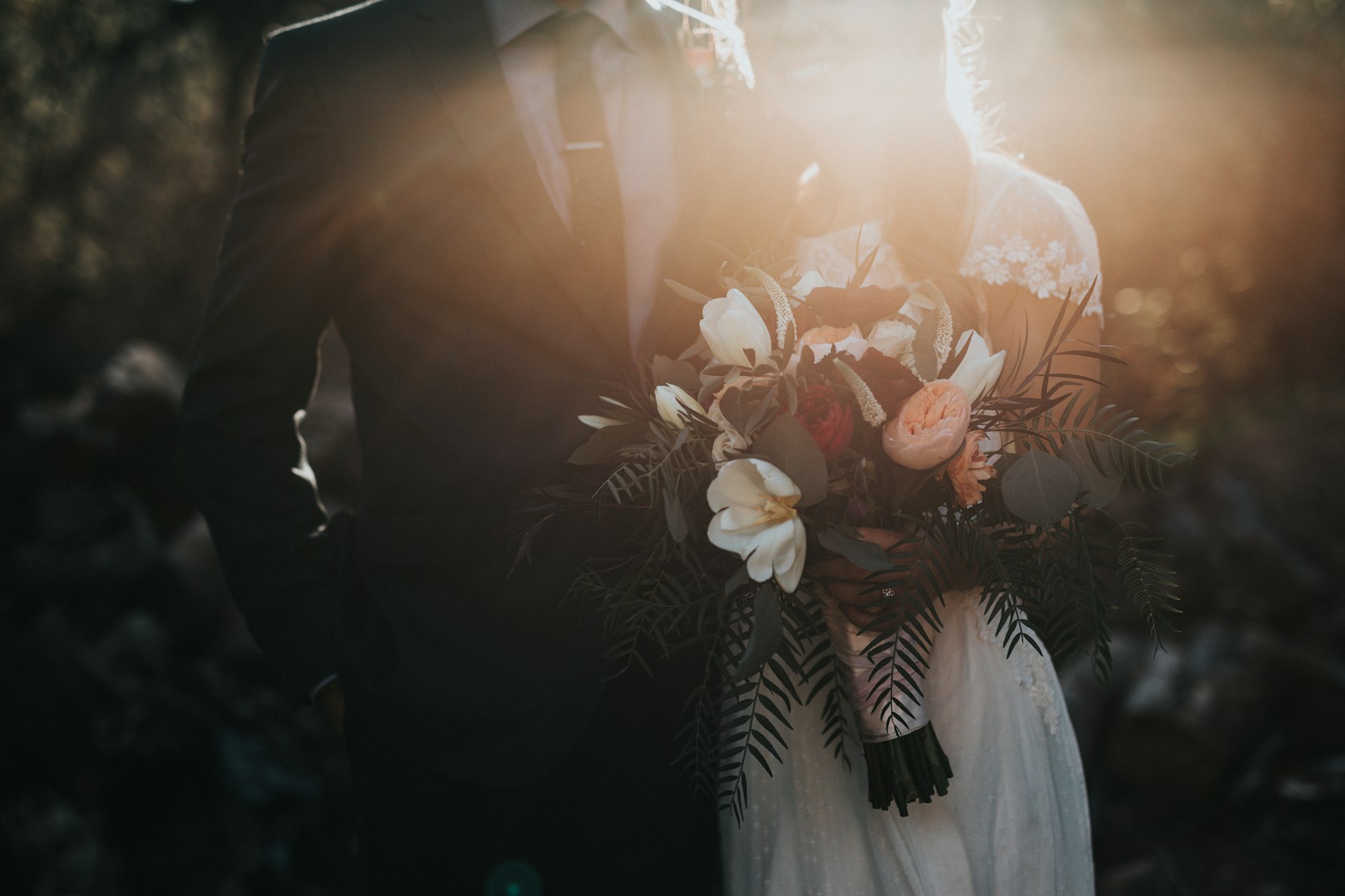 Bride and groom walking hand in hand at an outdoor wedding